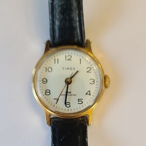 Vintage Timex Gold Case Watch with White Dial and Black Leather Strap